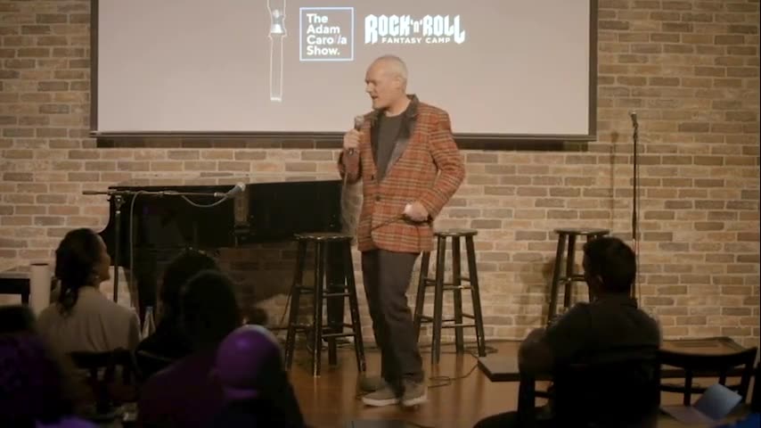 Mark Docherty performing a stand-up set at a comedy club